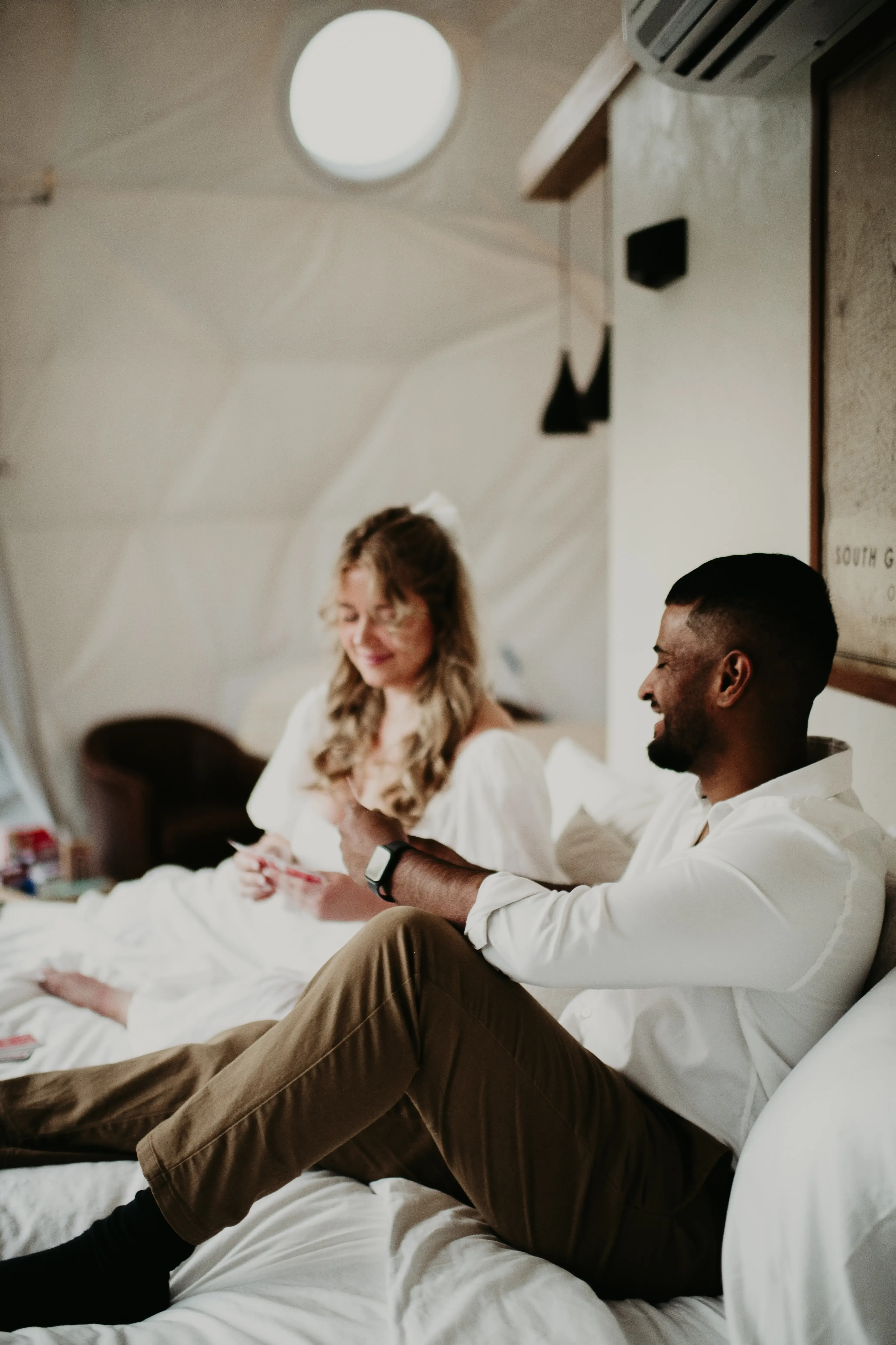 Couple Playing Cards In Bed