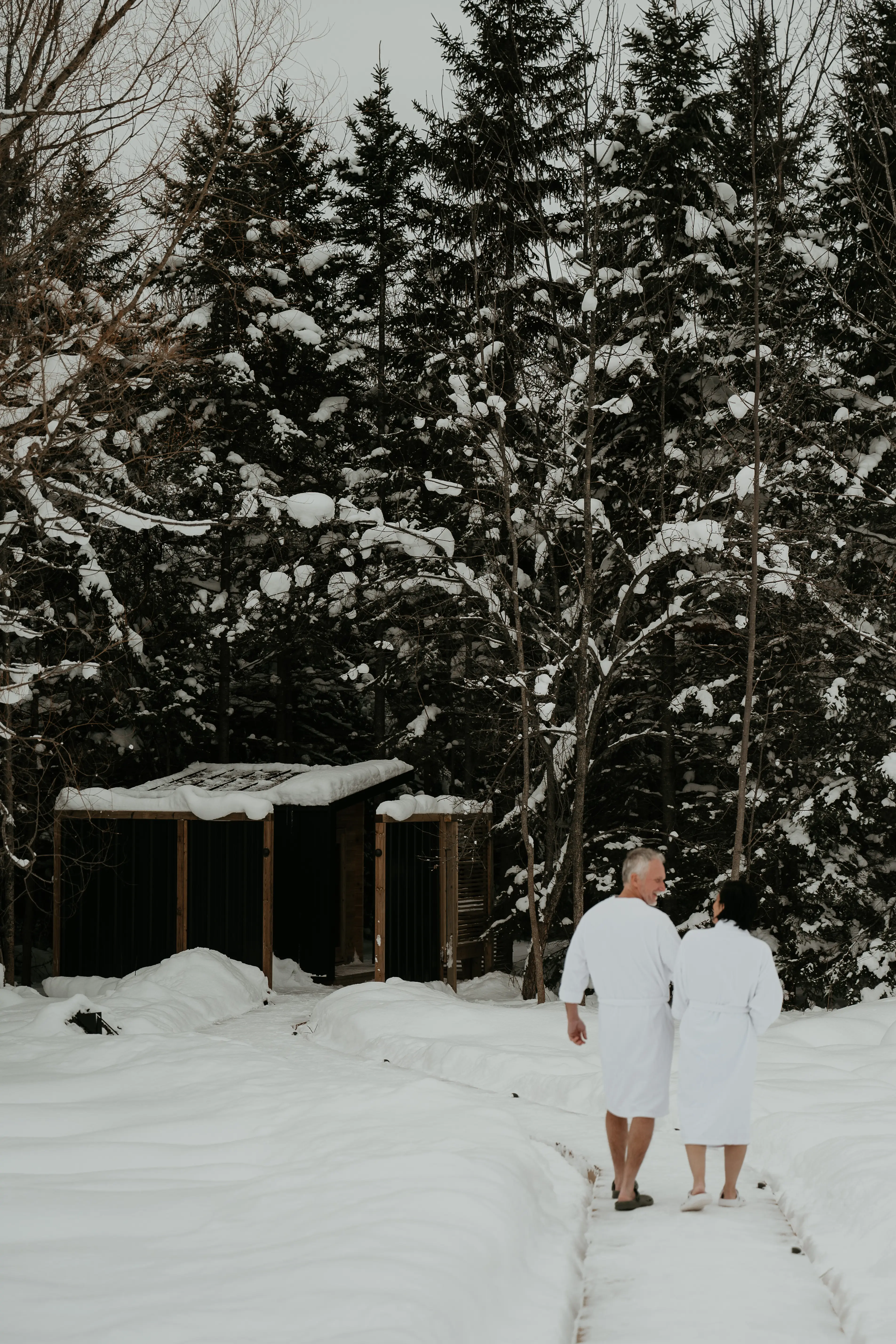 Couple Walking To The Sauna In Winter