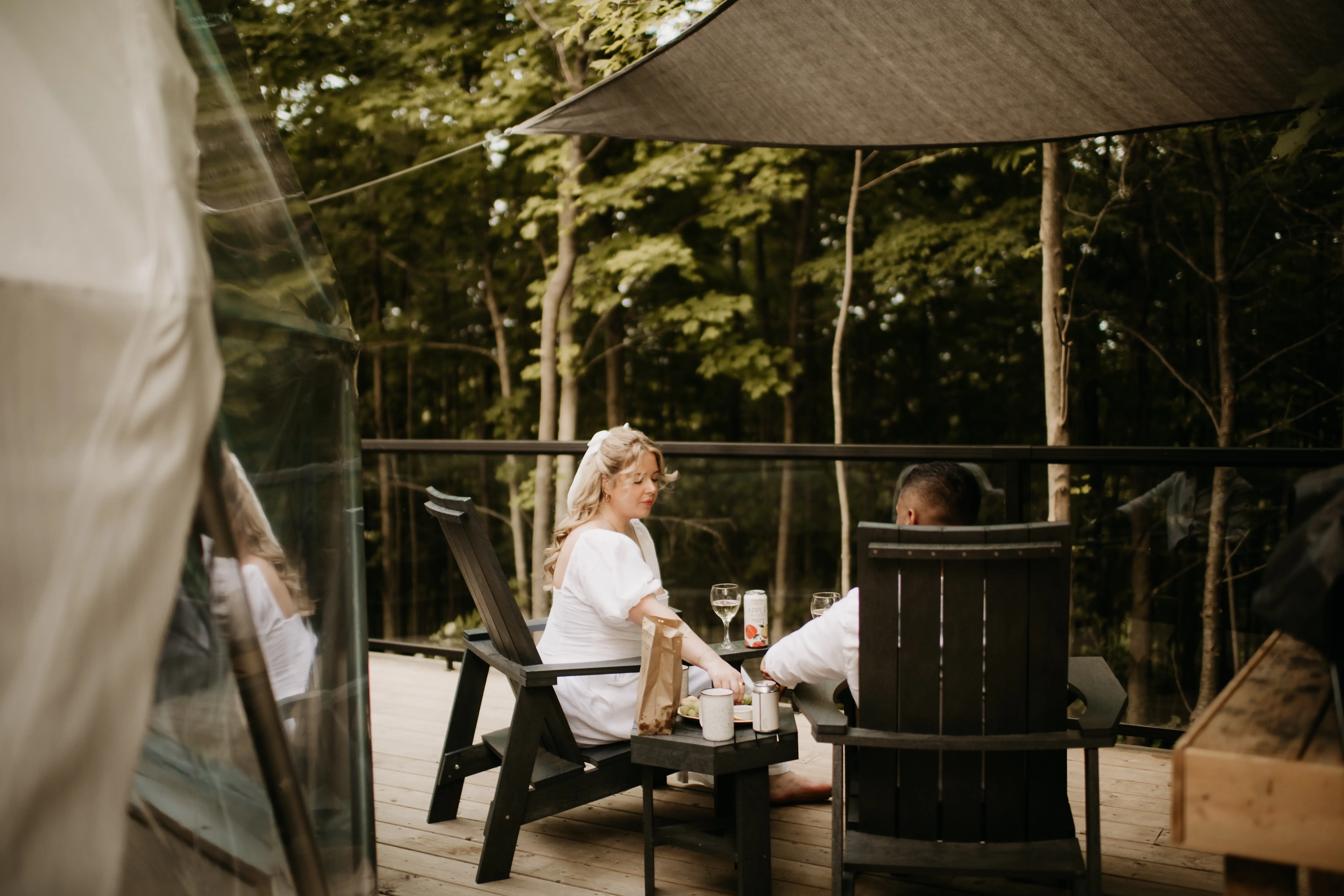 Couple Relaxing On The Forest Dome Deck