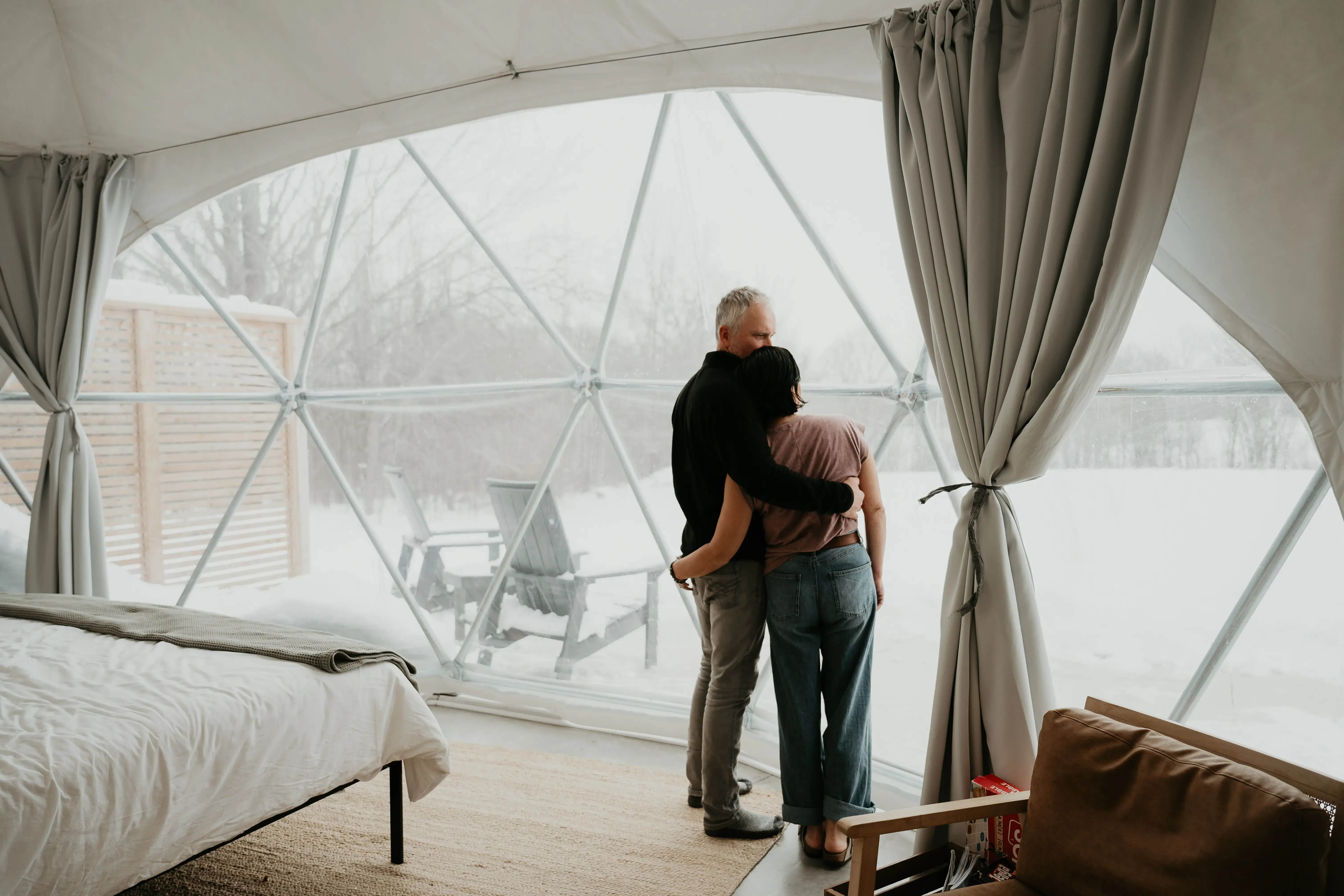 Couple Enjoying A Snowy Meadow Escape