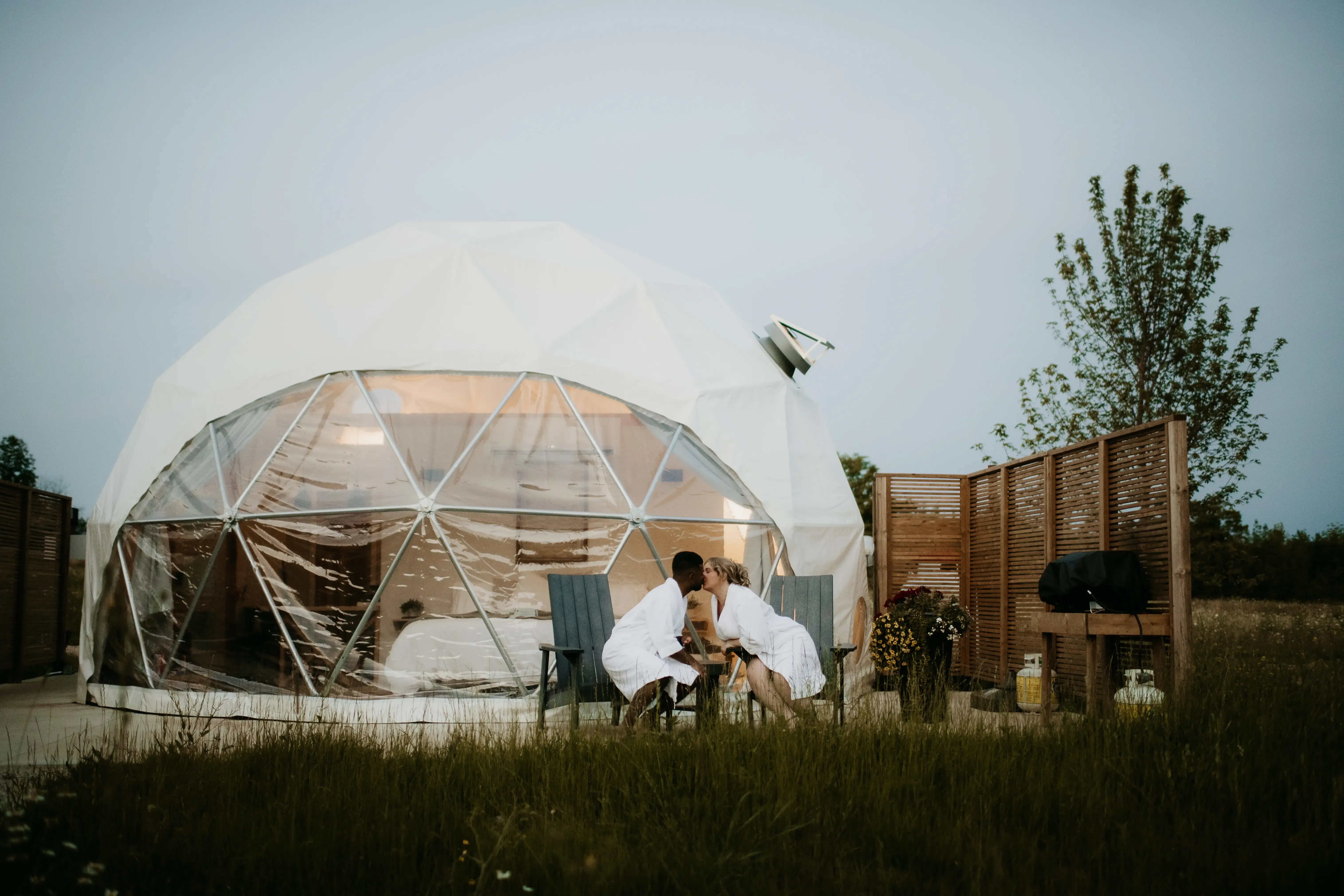 Couple Relaxing Outside The Meadow Dome