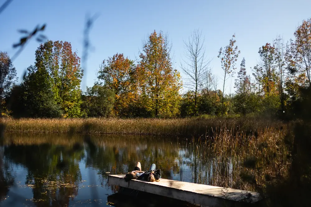 Couple Relaxing By The Pond