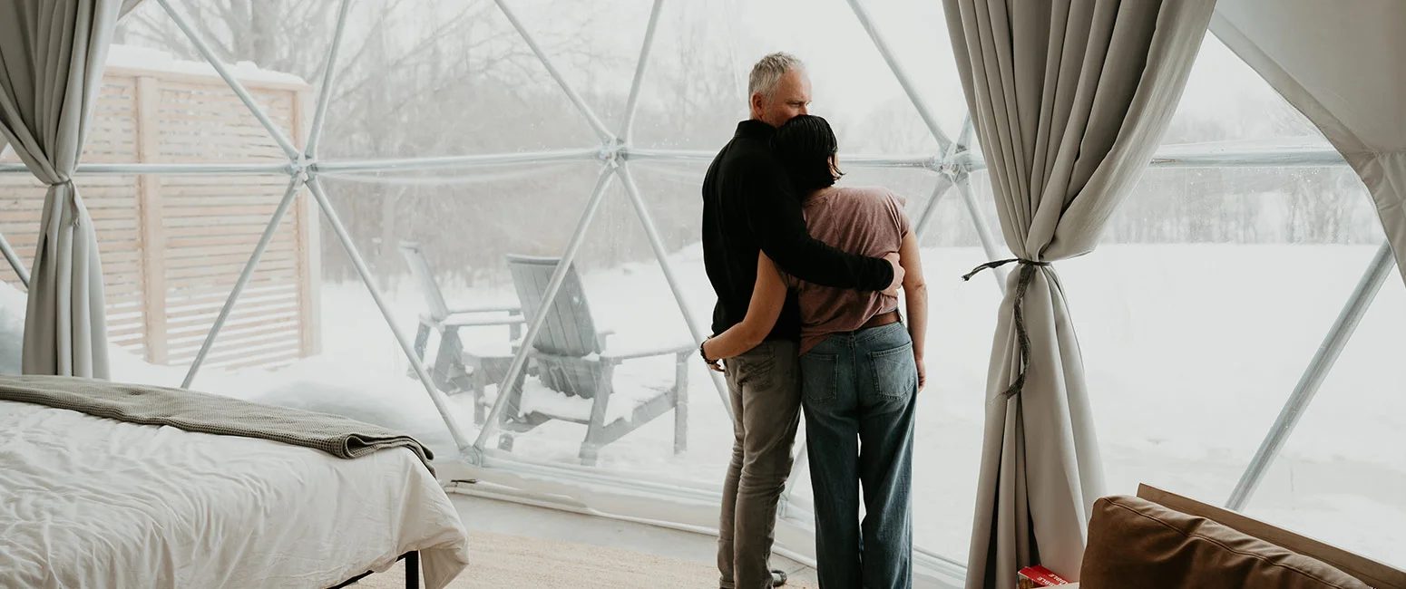 Couple Enjoying A Snowy Meadow Escape